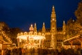 The carousel of the Christmas market in Rathaus park with City Hall in the center - Vienna, Austria Royalty Free Stock Photo