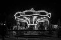 The carousel moving at night time. Black and white Royalty Free Stock Photo