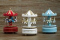 Carousel Music Boxes on Brown Wooden Background