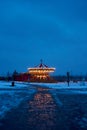 Carousel roundabout, galloper at the center an amusement park in the evening at night illumination. Outdoor vintage