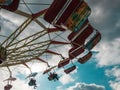 Carousel spinning and a cloudy sky during daytime