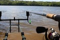 Carp fishing indicator. Warning for fishing, detailed swinger. Carp fishing on the dam. Fishing rod on a rod pod.
