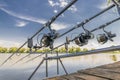 Carp fishing. Rods on rod pod on wood platform at lake Royalty Free Stock Photo