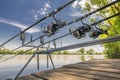 Carp fishing. Rods on rod pod on wood platform at lake