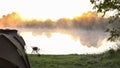 Carp fishing tent and rods on background of lake or river and nature in the morning Royalty Free Stock Photo