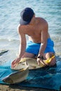 Carp fishing. Young fisherman catching a big common carps that slipped from his hands. Close up portrait.