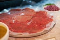 Carpaccio, closeup and food on plate for dinner with appetizer, fine dining and buffet of raw meat in restaurant. Beef Royalty Free Stock Photo