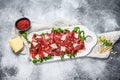 Carpaccio made of raw marbled beef. Gray background. Top view. Space for text