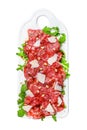 Carpaccio made of raw marbled beef. Isolated on white background. Top view.