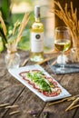 Carpaccio meat with parmesan cheese and arugula