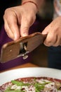 Carpaccio with parmesan, truffles and arugula on a white plate