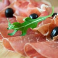 Carpaccio and prosciutto with olives