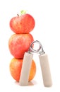 Carpal expander and a stack of three red apples Royalty Free Stock Photo