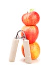 Carpal expander and a stack of three red apples Royalty Free Stock Photo