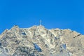 Carpathian mountains, Bucegi with Cross in top of Caraiman Peak, clouds, snow and fog, winter time landscape Royalty Free Stock Photo