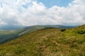 Carpathian mountains in Romania with hills covered by mountain meadows