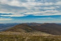 Carpathian Mountains top view landscape ridge autumn season dramatic weather time with cloudy blue sky background Royalty Free Stock Photo