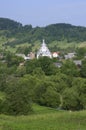 Carpathian village: catholic church, country houses, gardens and hill Royalty Free Stock Photo