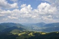 Carpathian village in a valley, forest and mountains under blue sky. Carpathians, Ukraine Royalty Free Stock Photo