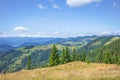 View of the mountains with beautiful clouds on the way to the Pysanyj stone. Carpathians