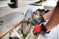 Carpenter adjusting the blade on a circular saw