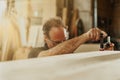 Carpenter adjusting a clamp on a plank of wood