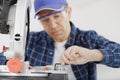 carpenter adjusting mitter saw