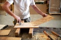 Carpenter applying glue to attach briar root panel Royalty Free Stock Photo