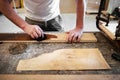 Carpenter applying stain to a briar root panel