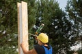 Carpenter applying wood glue to a panel