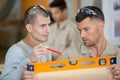 carpenter and apprentice installing luxury fitted kitchen Royalty Free Stock Photo