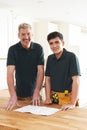 Carpenter And Apprentice Installing Luxury Fitted Kitchen Royalty Free Stock Photo