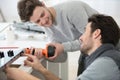 carpenter and apprentice installing luxury fitted kitchen Royalty Free Stock Photo