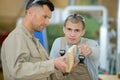 carpenter with apprentice in training period Royalty Free Stock Photo
