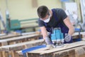 Carpenter apprentice working on wood Royalty Free Stock Photo