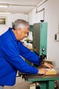 Carpenter on a band saw Royalty Free Stock Photo