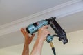 Carpenter brad using nail gun to Crown Moulding framing trim, Royalty Free Stock Photo