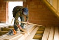 Carpenter building new floor of a loft room