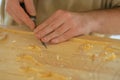 Carpenter carving wood with chisel at medival festival - close up