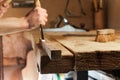 Carpenter carving wood with a chisel