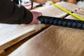 Carpenter checking the flat surface , building an oak live edge table