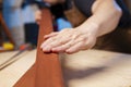 A carpenter checking smoothness of wood material. Woodworker preparing planks for work Royalty Free Stock Photo
