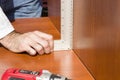 Carpenter checks the angle of joining the furniture boards using the angle bracket. Royalty Free Stock Photo