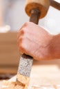 Carpenter with chisel and hammer Royalty Free Stock Photo