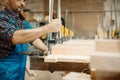 Carpenter clamps the board in a vise, woodworking