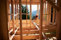 Carpenter constructing wooden frame house.