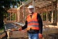 Carpenter constructing wooden frame house.