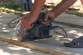 Carpenter cuts a Board manual electric saw ,close-up , concept building and repair Royalty Free Stock Photo