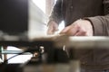 Carpenter cutting a piece with electric circular saw over table Royalty Free Stock Photo