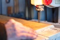 Carpenter Cutting a Piece Of Wood With Bandsaw In Workshop Royalty Free Stock Photo